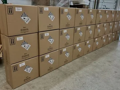 Dangerous goods packaging - UN specification fibreboard boxes stacked with handling labels in our Richmond BC warehouse